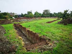 Trenches dug ready for the slinkies for a ground source heat pump install